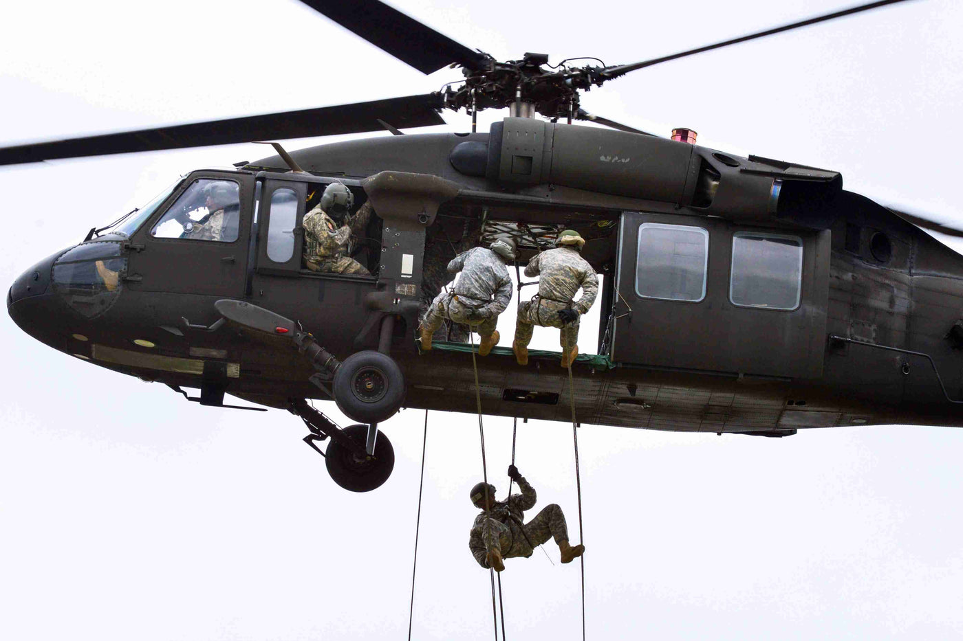 soldiers rappelling from a helicopter at air assault school